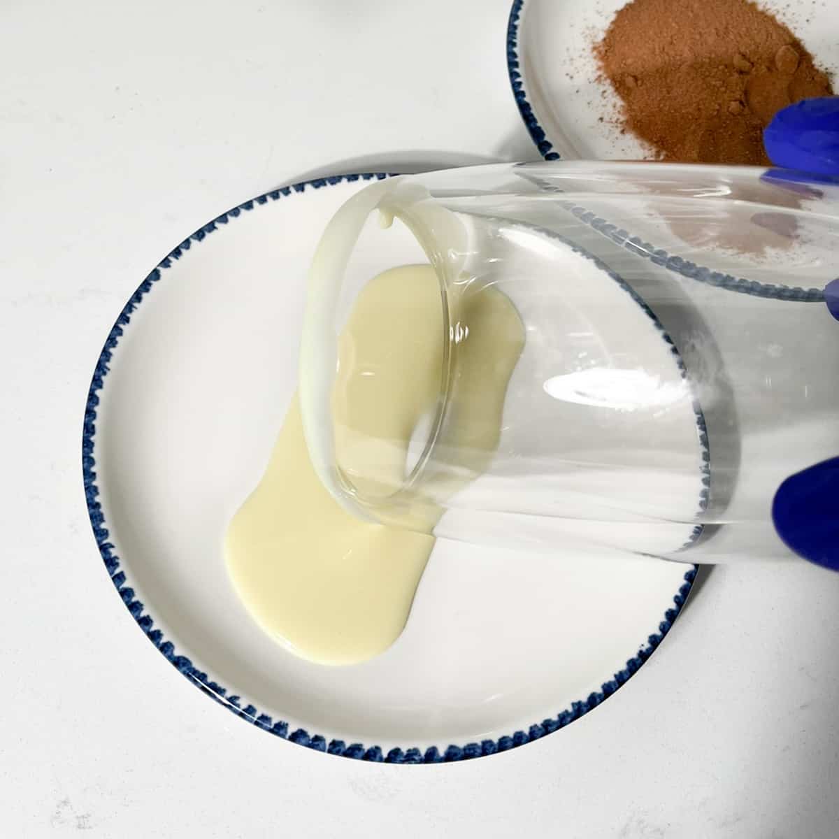 Rolling the edge of the glass in condensed milk.