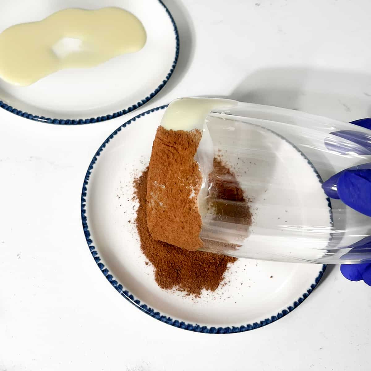 Rolling the edge of the glass in milo powder.