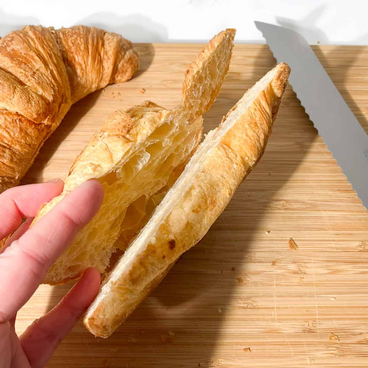 Slicing the croissant half way through.