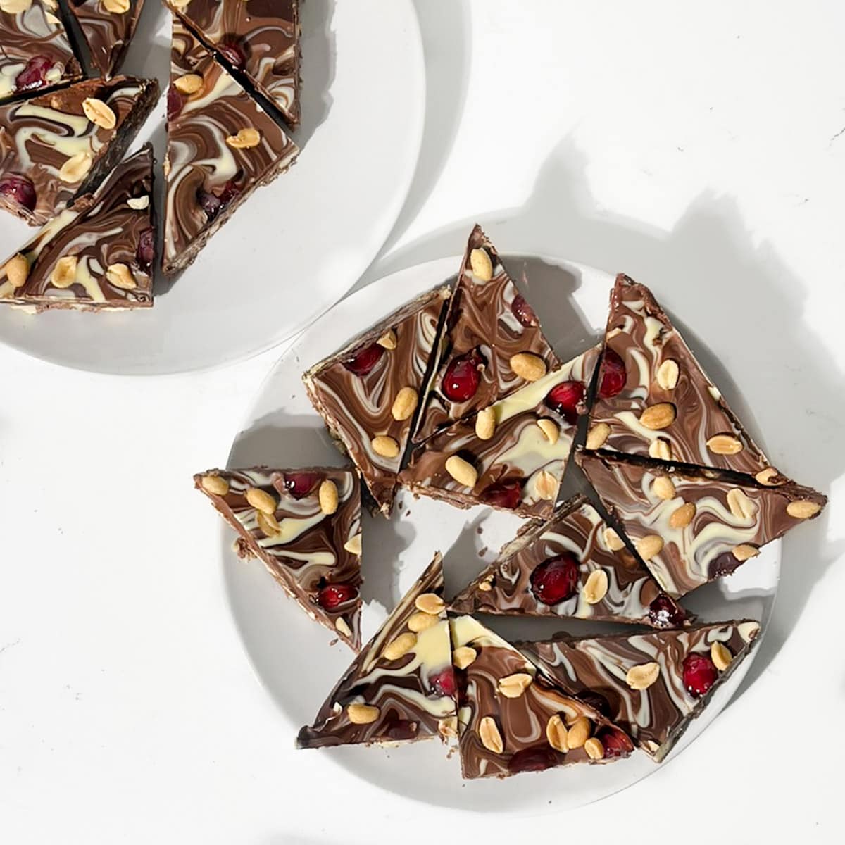 Chocolate tiffin triangles on a white plate.