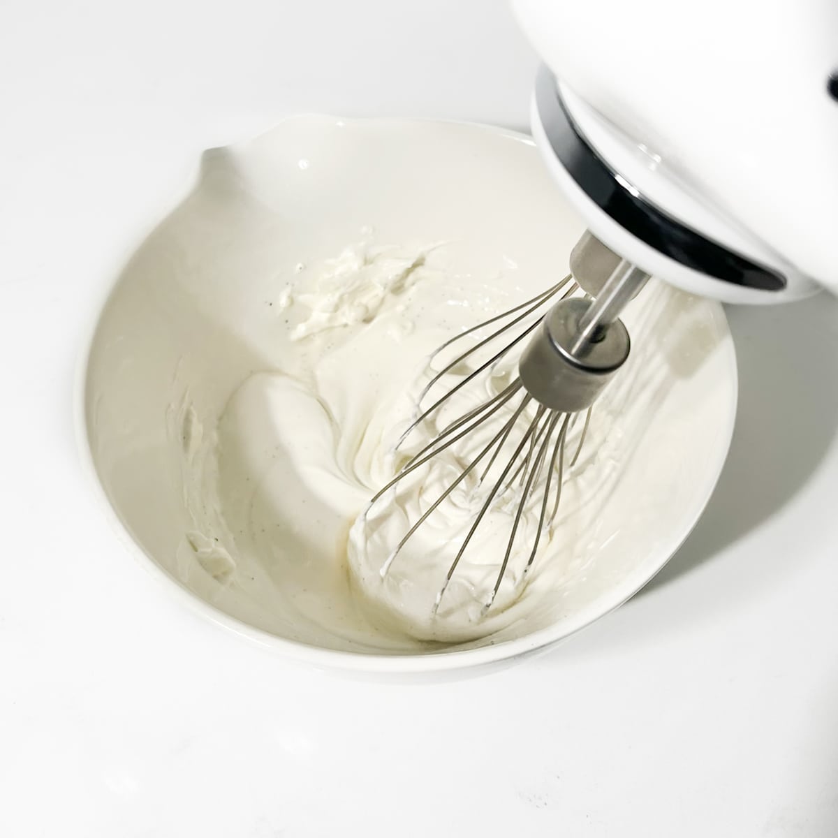 Whipping the mascarpone in a small bowl until smooth.