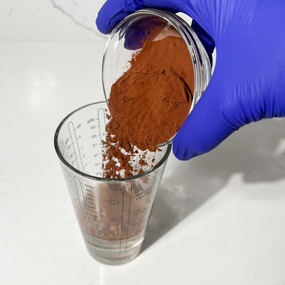 Adding cocoa powder to boiled water. 