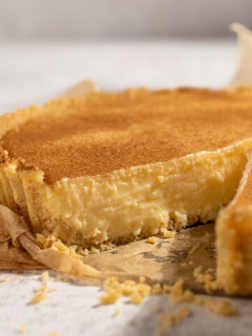 South African milk tart with condensed milk, cinnamon topping and a fluted Tennis biscuit crust.