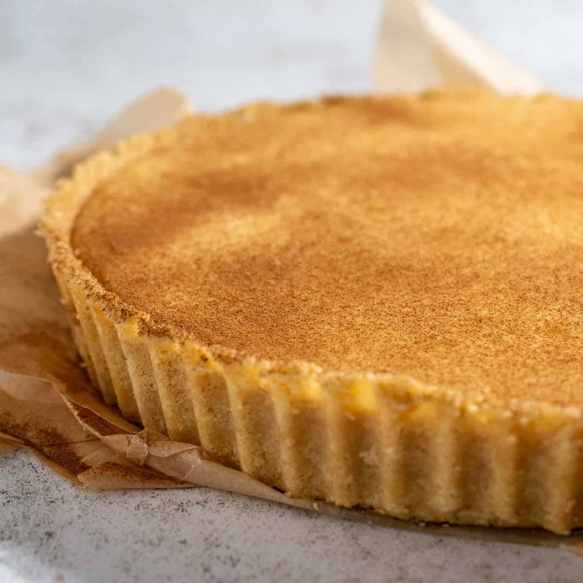 A milk tart on a white background.