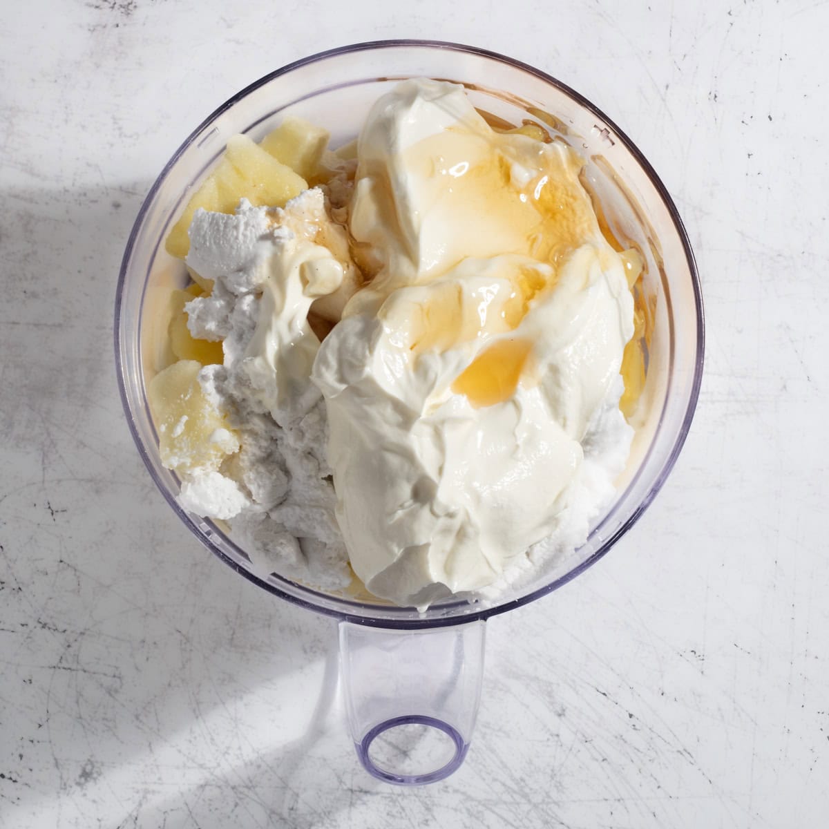 All the ingredients for the pina colada smoothie in a blender.