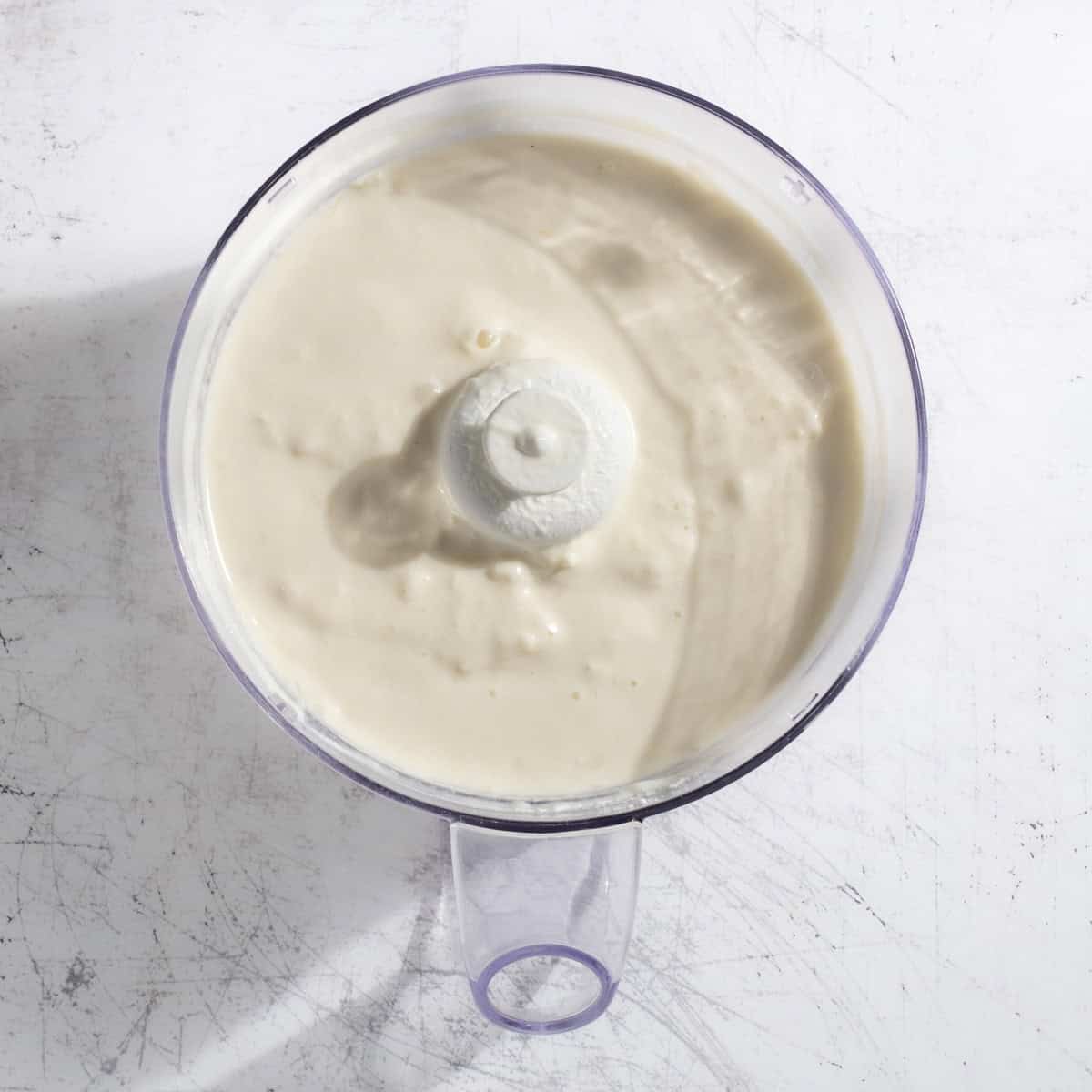 A complete pina colada smoothie in a blender.