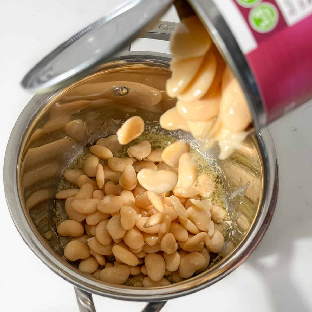 Draining butter beans in a colander.