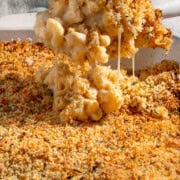 A scoop of baked three cheese mac and cheese with crispy garlic Parmesan crumb topping.